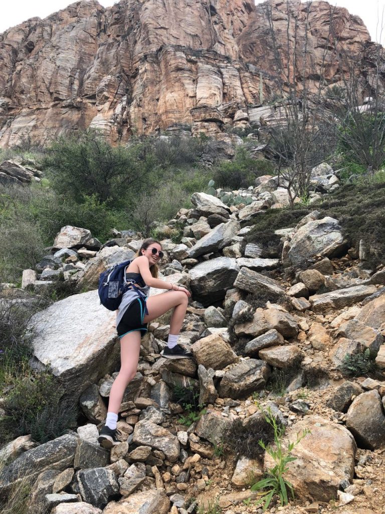 Kaylin climbing some rocks along the Phoneline Trail